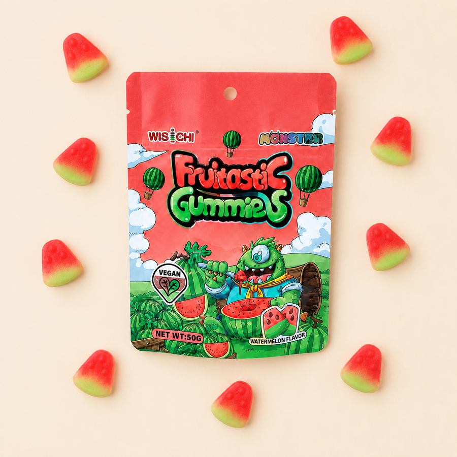 A bag of Wisichi Fruitaslic Gummies (Watermelon flavor) is displayed on a light beige background, surrounded by scattered watermelon-shaped gummies. The packaging features a bright red top section and a colorful cartoon illustration of a green monster eating watermelon slices.