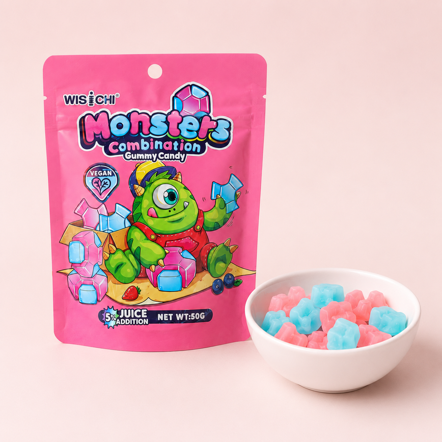 A pink stand-up pouch of Wisichi Monsters Combination Gummy Candy next to a small white bowl filled with pink and blue gummy candies, set against a solid pale pink background.